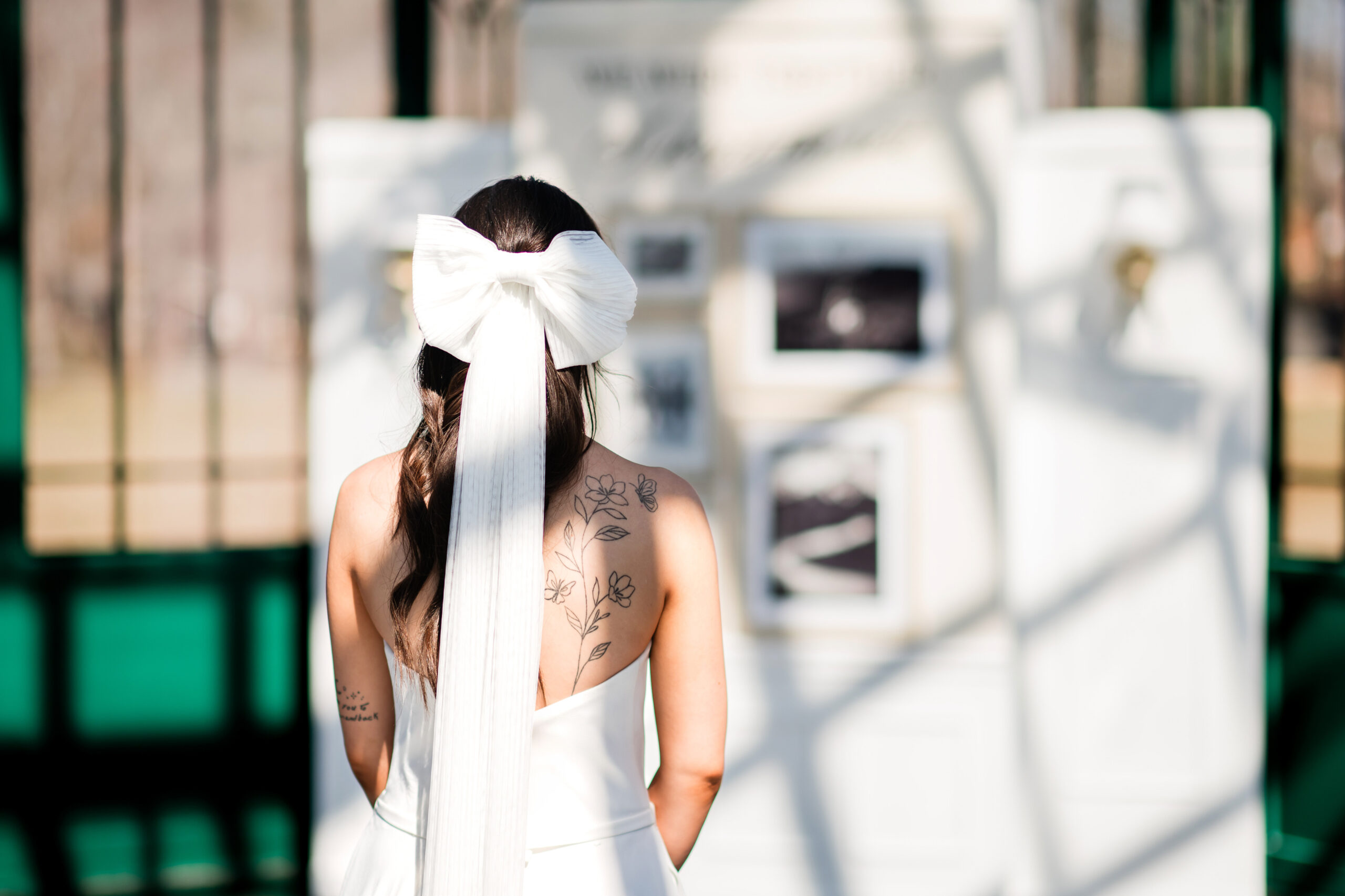 Creative wedding signage display for modern wedding featuring a bride wearing a beautiful bow veil