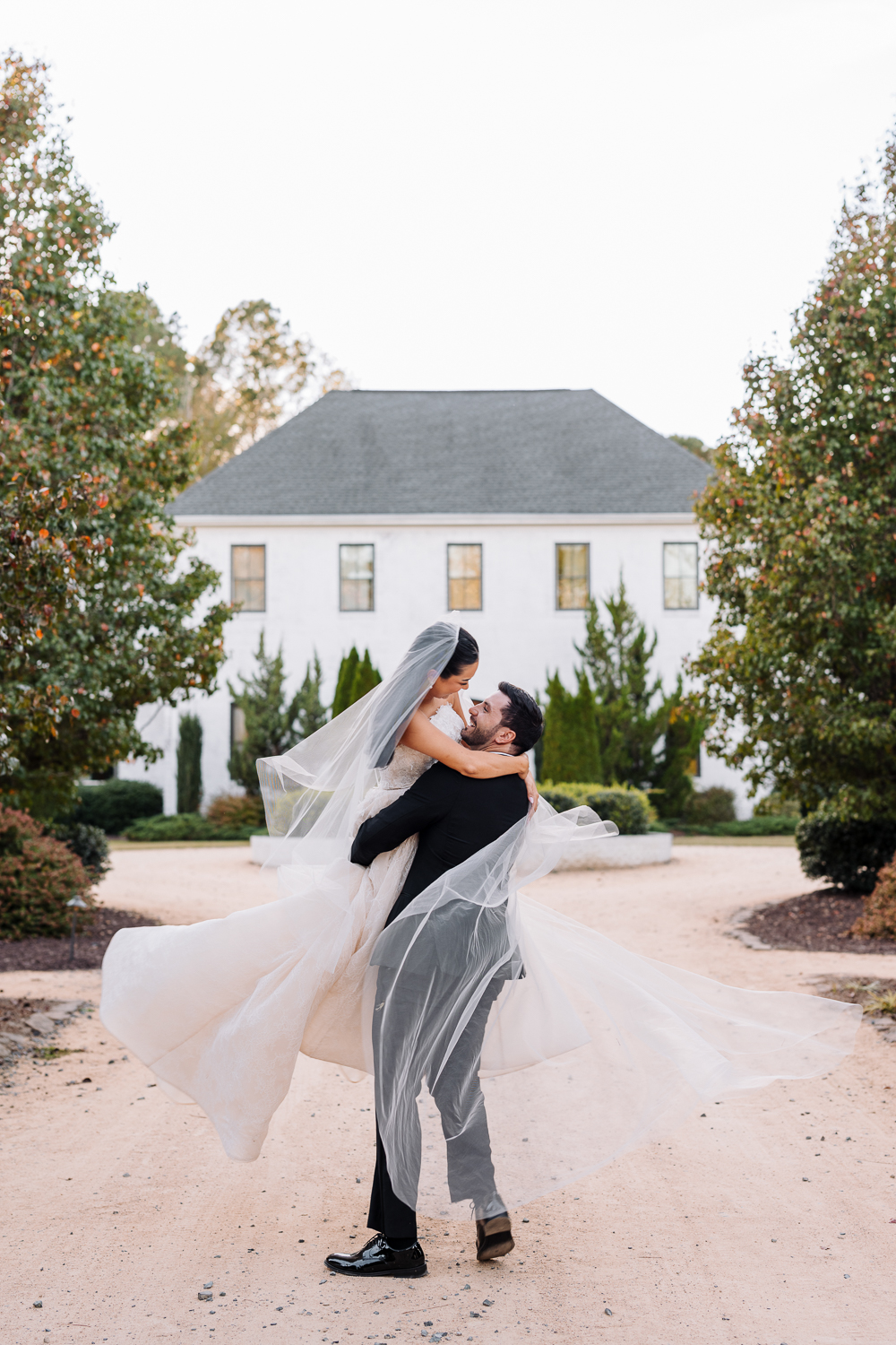 Bride and groom standing together in front of The Bradford wedding venue in North Carolina