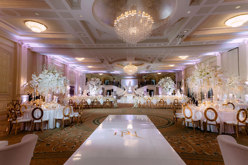 Elegant wedding reception at Prestonwood Country Club with lush white florals and gold accents